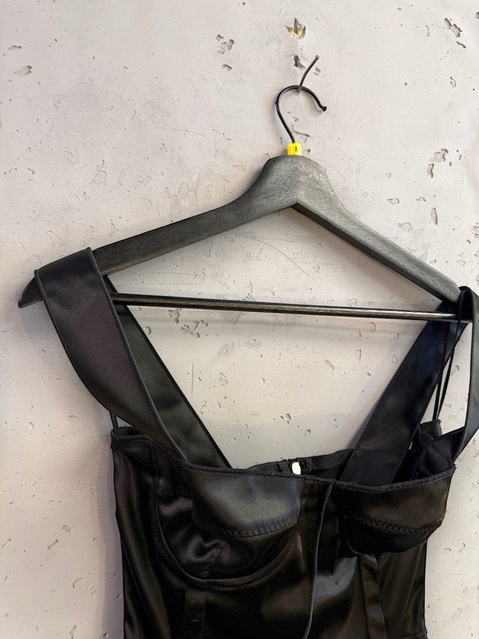 BERLIN VINTAGE CORNER black satin corset tank top with wide straps and structured molded cups on a hanger