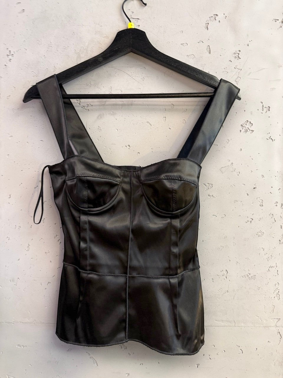 BERLIN VINTAGE CORNER black satin corset tank top with wide straps and structured molded cups on a hanger.
