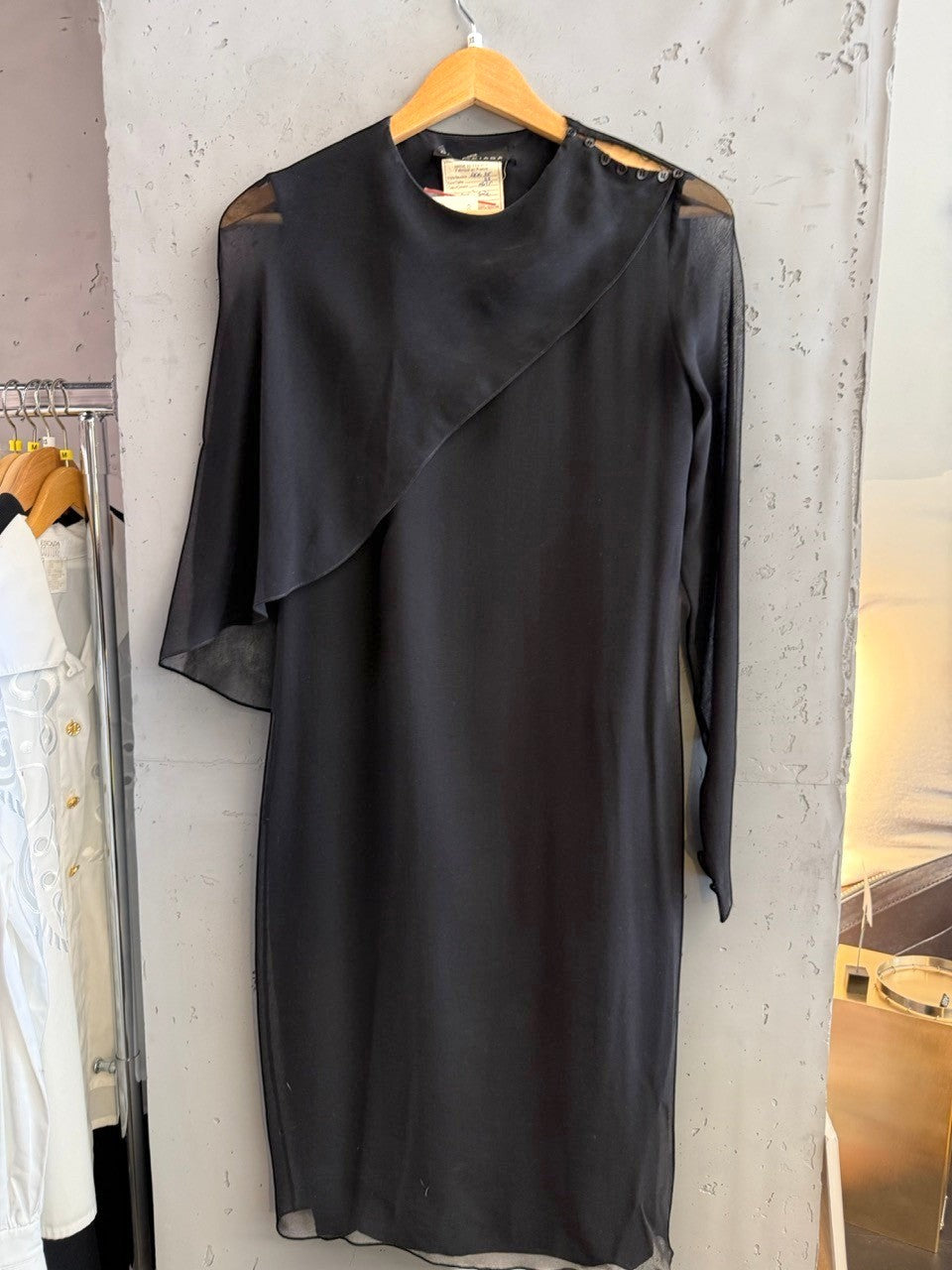 BERLIN VINTAGE CORNER black midi dress with sheer sleeves, asymmetrical neckline, and button details.