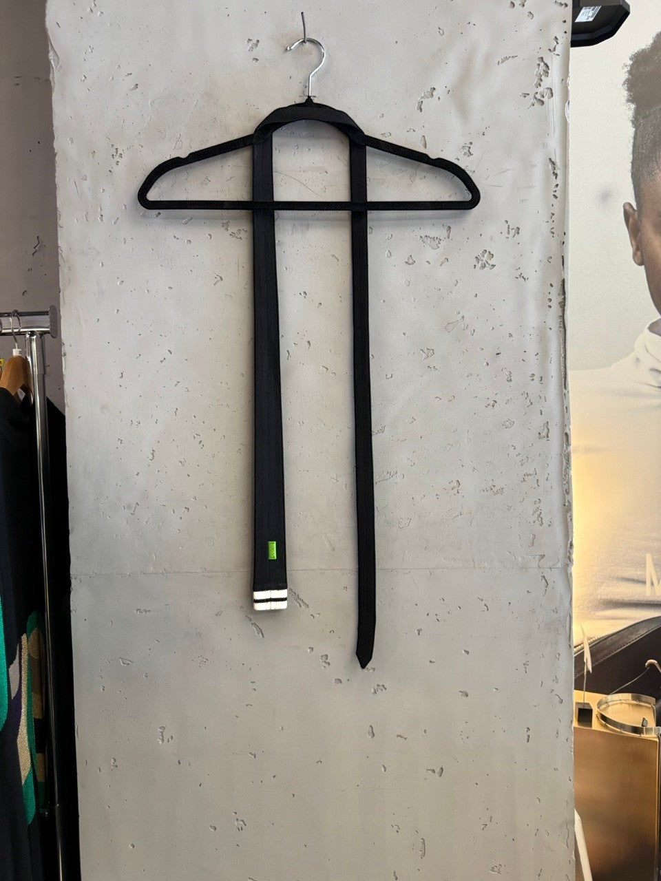 BERLIN VINTAGE CORNER black tie with white stripes at the tip and a green BOSS logo tag.