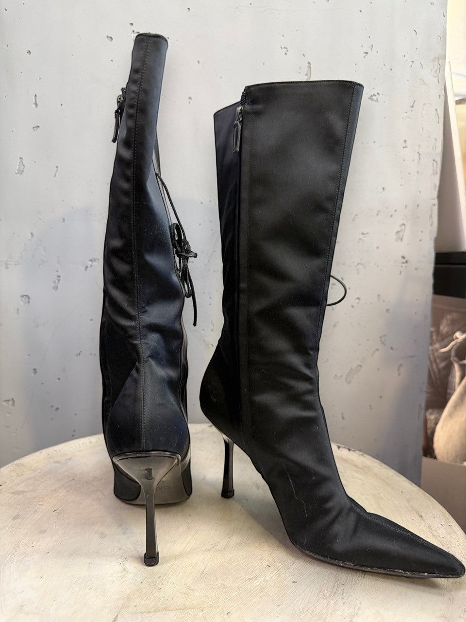 BERLIN VINTAGE CORNER black knee-high boots with pointed toe, stiletto heel, side zipper, and lace-up back detail.