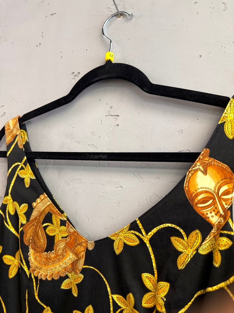BERLIN VINTAGE CORNER black mini dress with gold and brown tribal print, V-neck, sleeveless. Cotton blend.