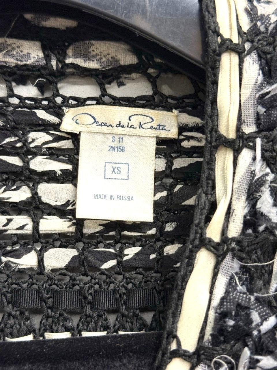 BERLIN VINTAGE CORNER black and white open-weave knit cardigan with fringe details and button closures.
