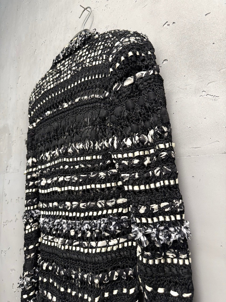 BERLIN VINTAGE CORNER black and white open-weave knit longline cardigan with fringe details and button closures.