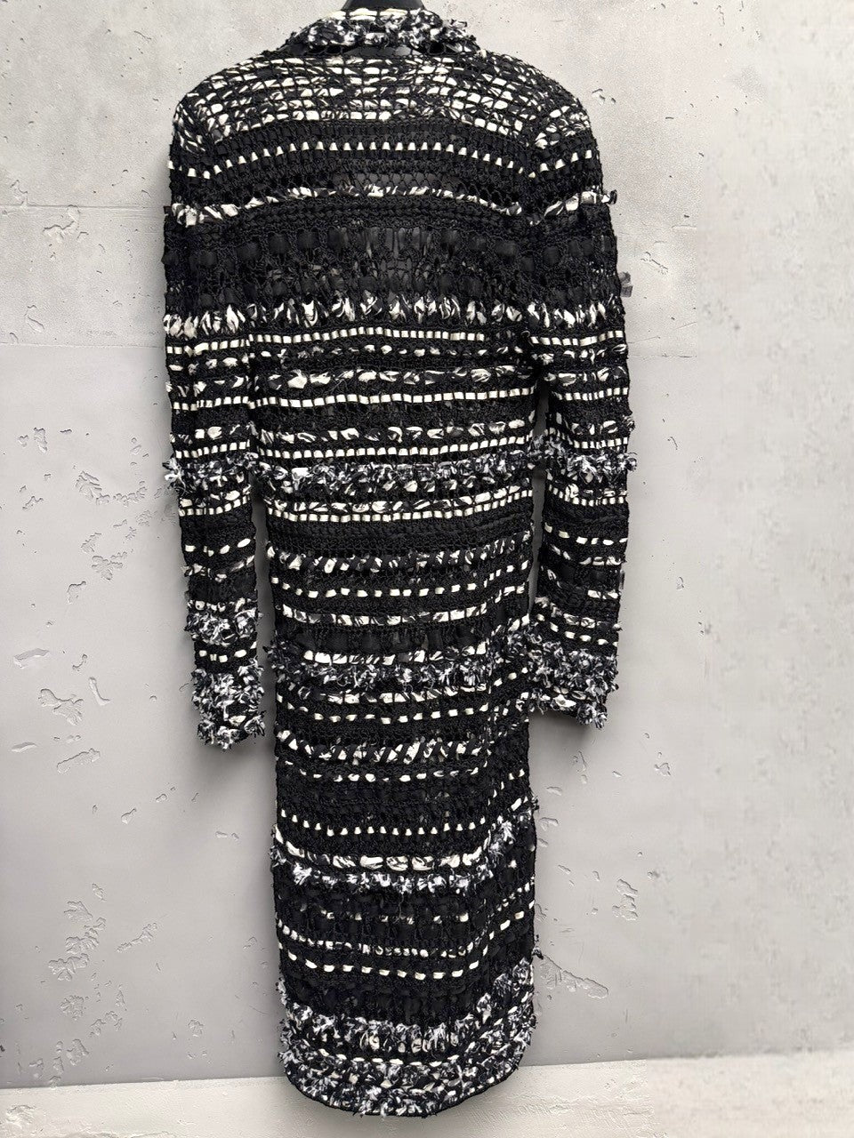 BERLIN VINTAGE CORNER black and white open-weave knit longline cardigan with fringe details and button closures.