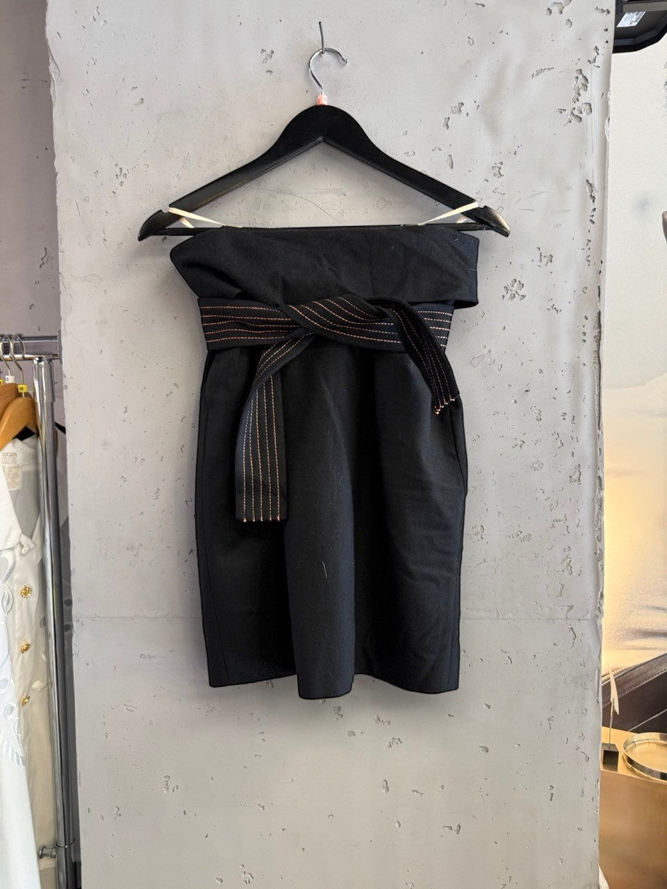 BERLIN VINTAGE CORNER black wool blend wide leg trousers with rose gold stitching detail on wrap belt.