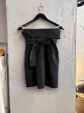 BERLIN VINTAGE CORNER black wool blend wide leg trousers with rose gold stitching detail on wrap belt.
