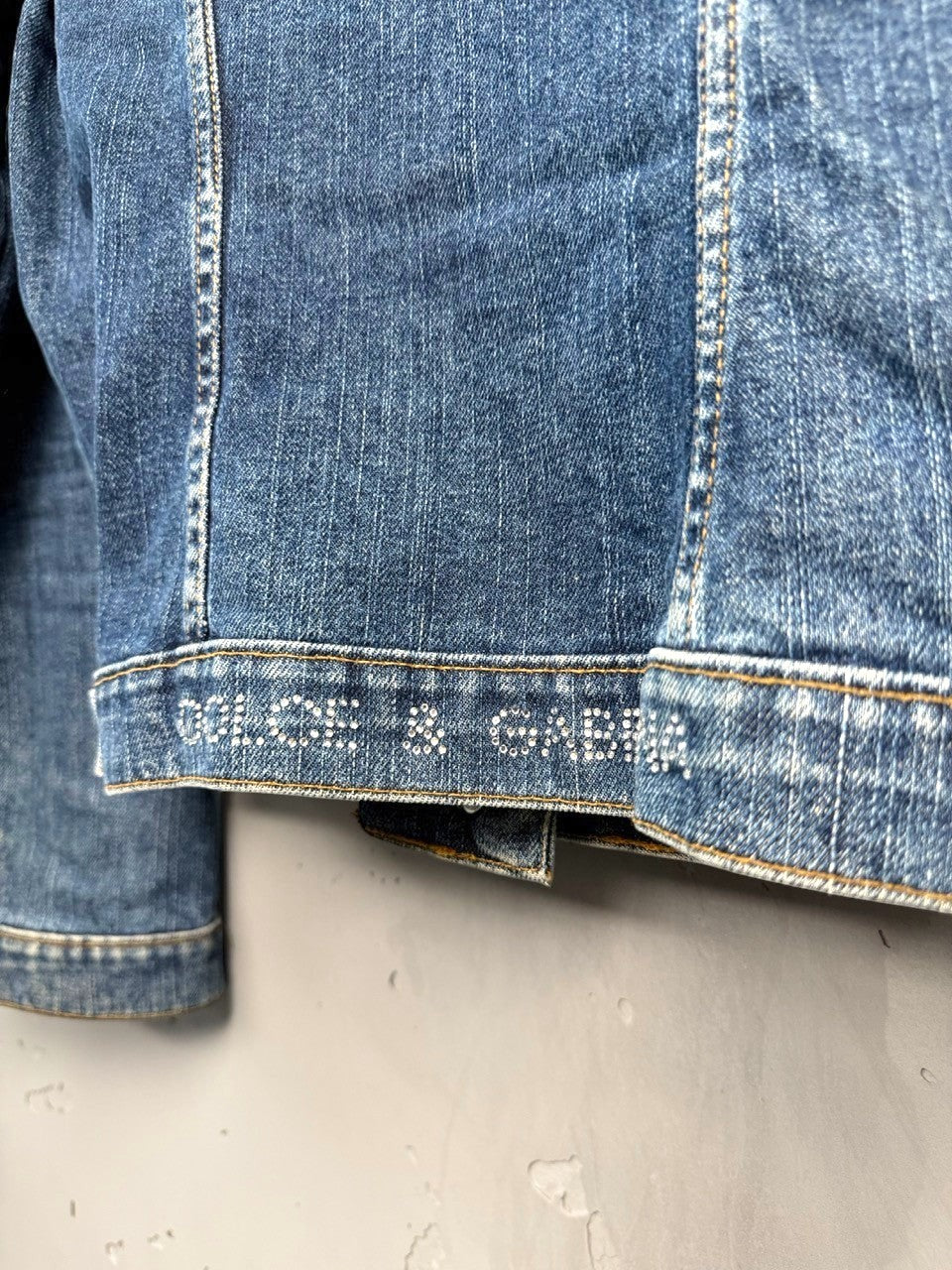 BERLIN VINTAGE CORNER blue denim jacket with rhinestone embellished logo on hem.