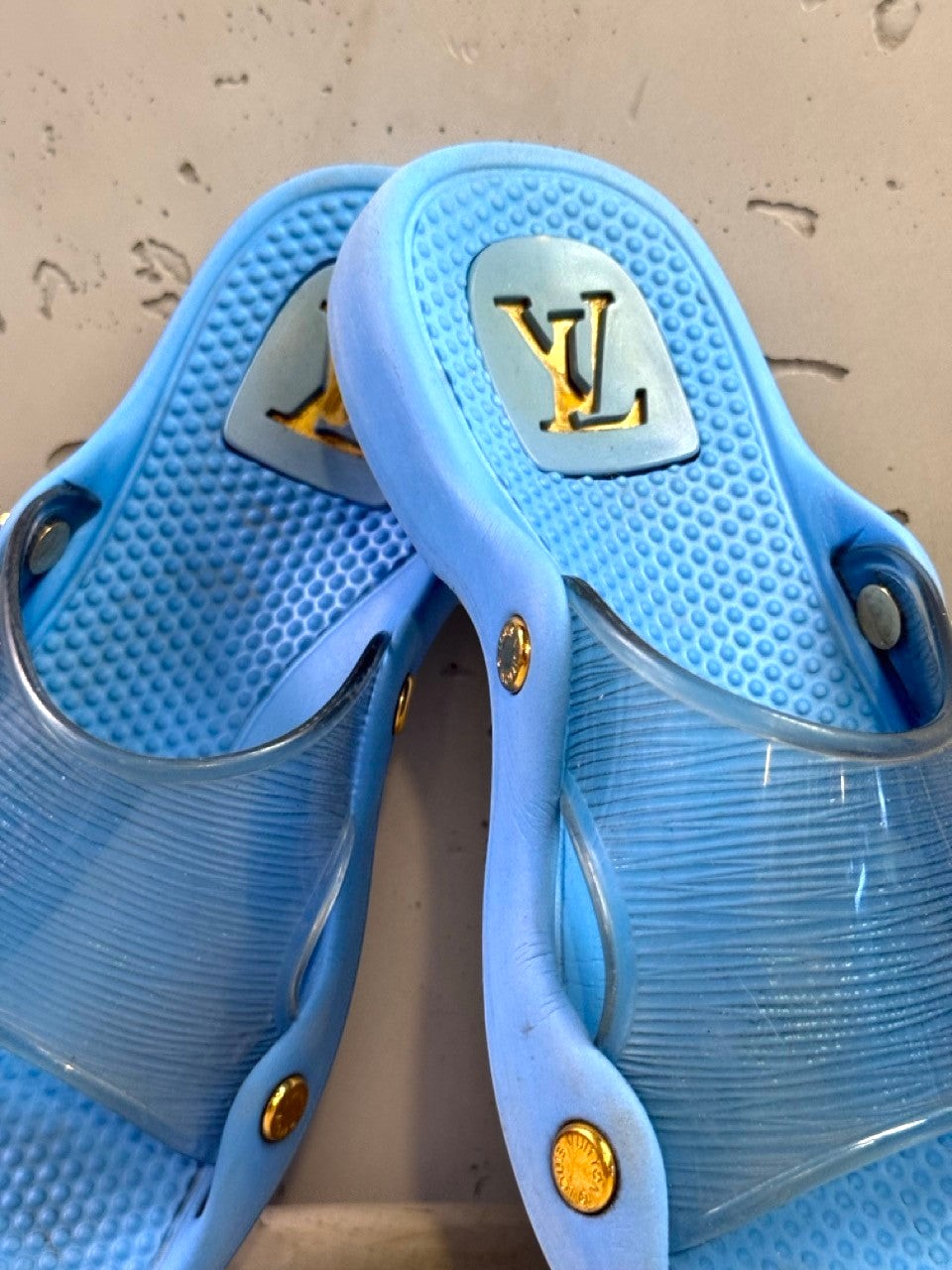BERLIN VINTAGE CORNER blue Louis Vuitton slides with translucent straps and gold-tone hardware.