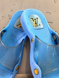 BERLIN VINTAGE CORNER blue Louis Vuitton slides with translucent straps and gold-tone hardware.