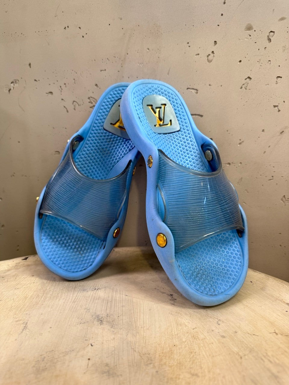 BERLIN VINTAGE CORNER blue Louis Vuitton slides with translucent straps and gold-tone hardware.