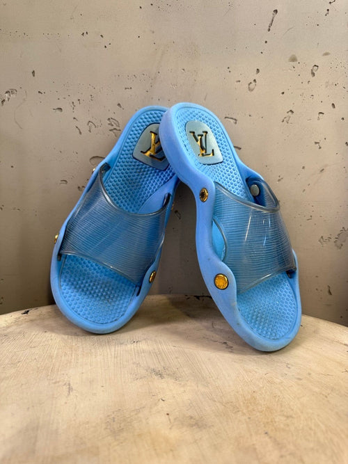 BERLIN VINTAGE CORNER blue Louis Vuitton slides with translucent straps and gold-tone hardware.