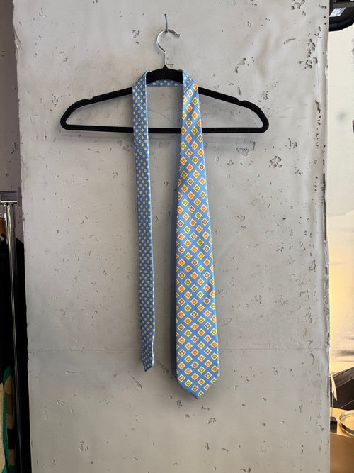 BERLIN VINTAGE CORNER blue silk tie with geometric diamond pattern in yellow, orange, and green. Reverse has a blue micro-dot pattern.