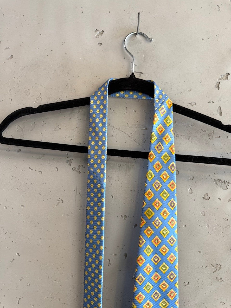 BERLIN VINTAGE CORNER blue silk tie with geometric diamond pattern in yellow, orange, and green.