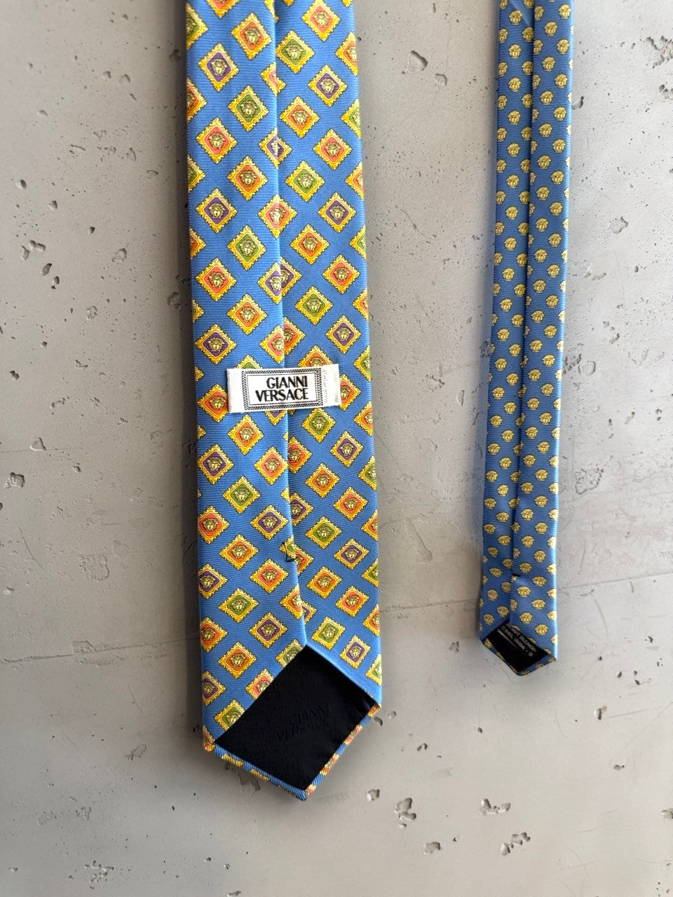 BERLIN VINTAGE CORNER blue silk tie with geometric diamond pattern in yellow, orange, and green.