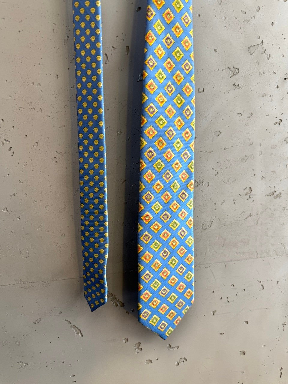 BERLIN VINTAGE CORNER blue silk tie with geometric diamond pattern in yellow, orange, and green. Reverse has micro-dot pattern.
