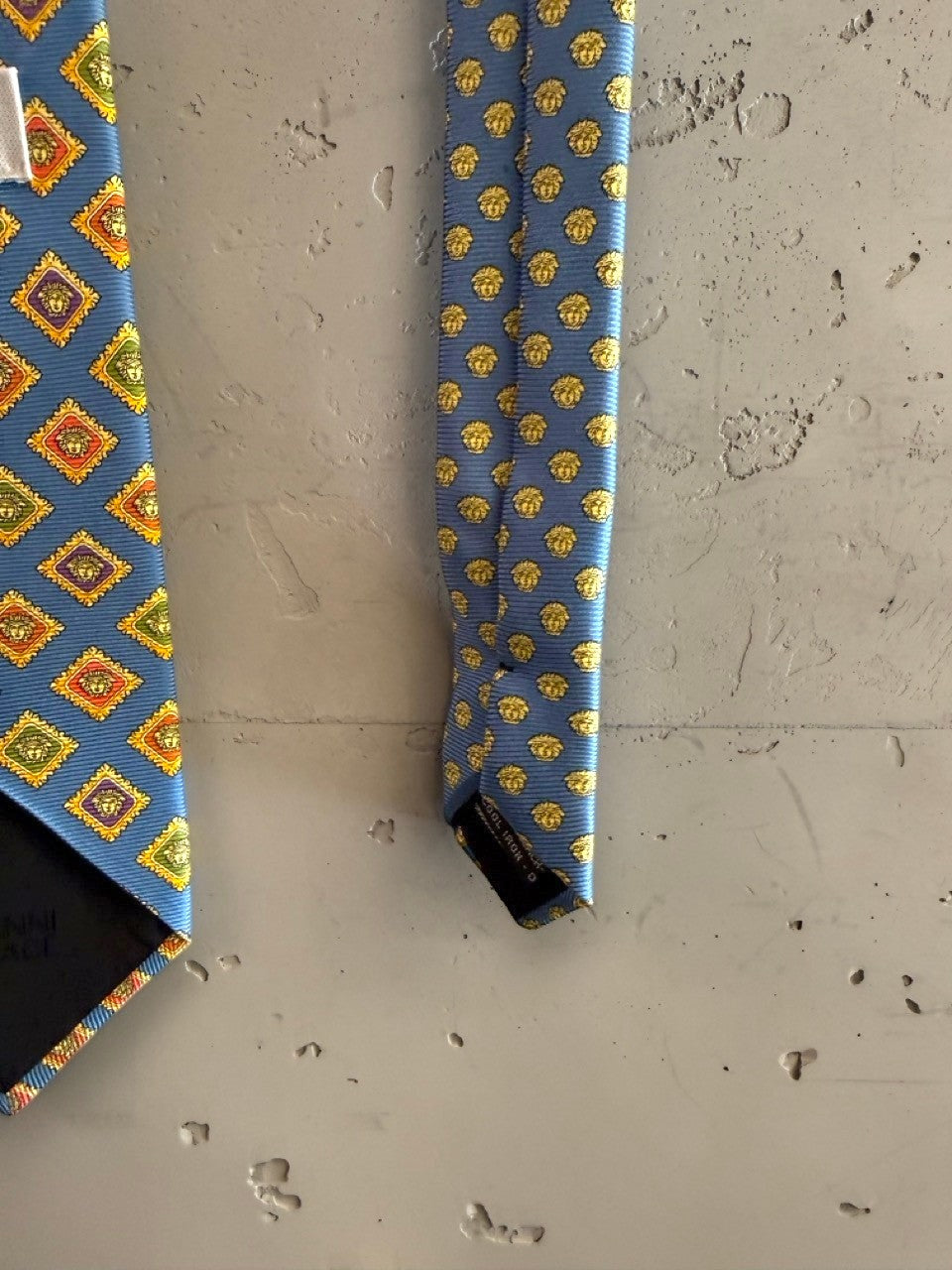 BERLIN VINTAGE CORNER blue silk tie with geometric diamond pattern in yellow, orange, and green.