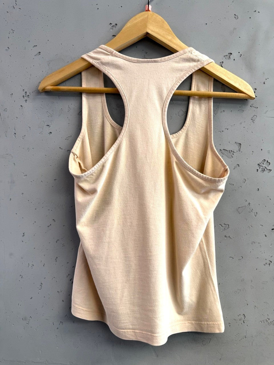 BERLIN VINTAGE CORNER blush pink embellished racerback tank top with subtle logo detail. Soft, breathable fabric.