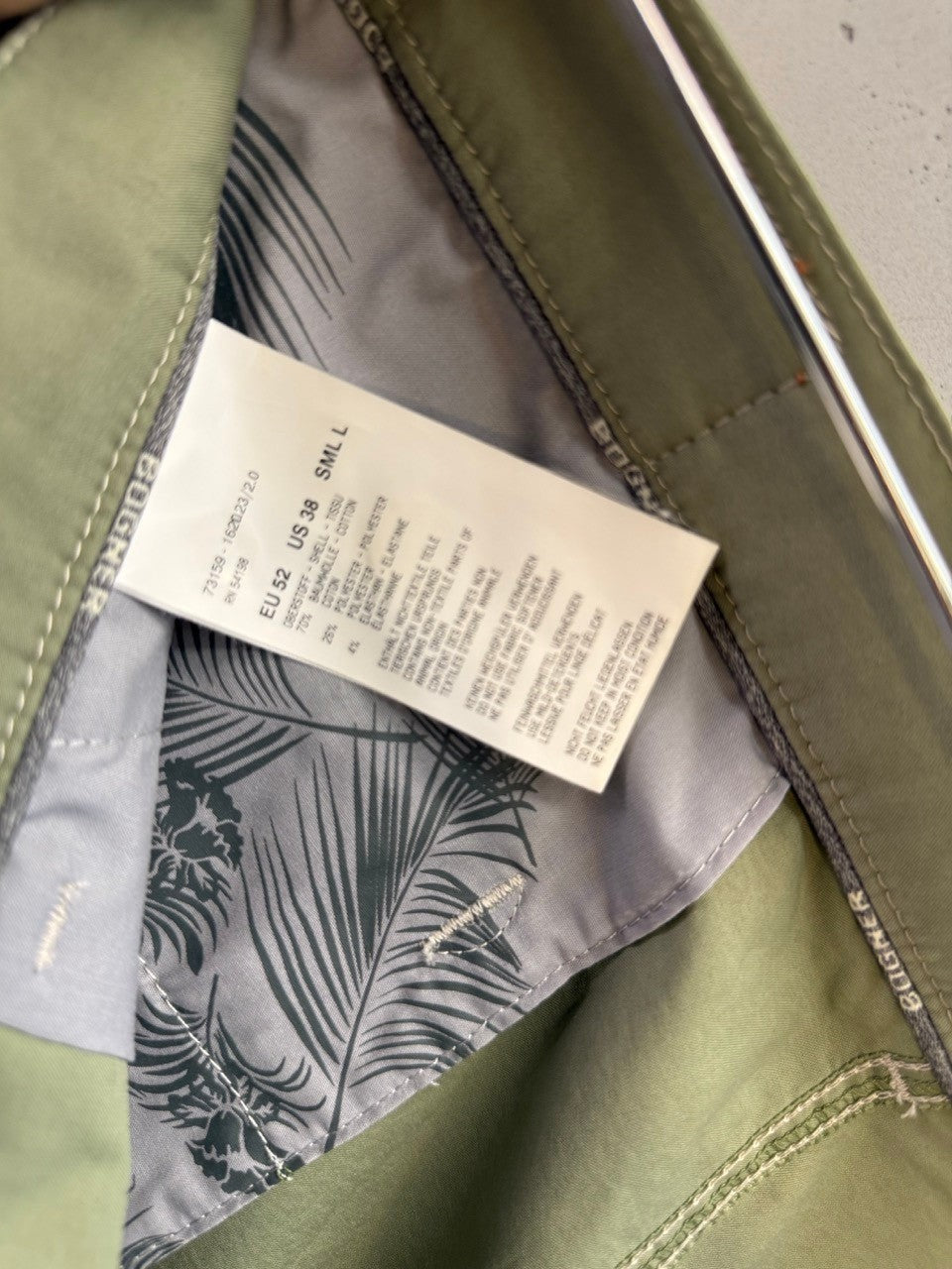 BERLIN VINTAGE CORNER sage green Bogner cotton shorts with palm leaf print interior lining and care label details.