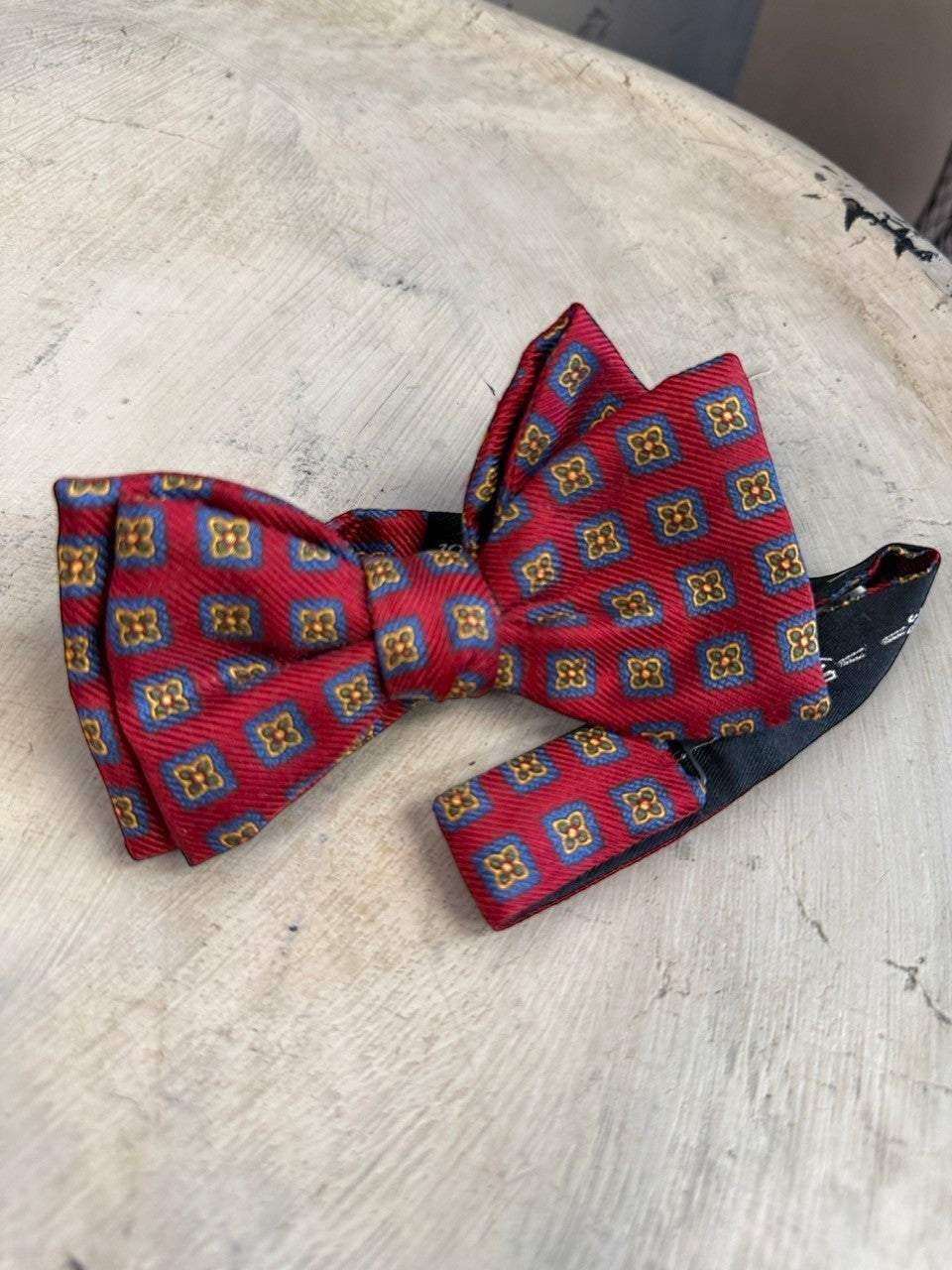 BERLIN VINTAGE CORNER burgundy silk bow tie with blue squares and gold floral geometric pattern. Adjustable strap.