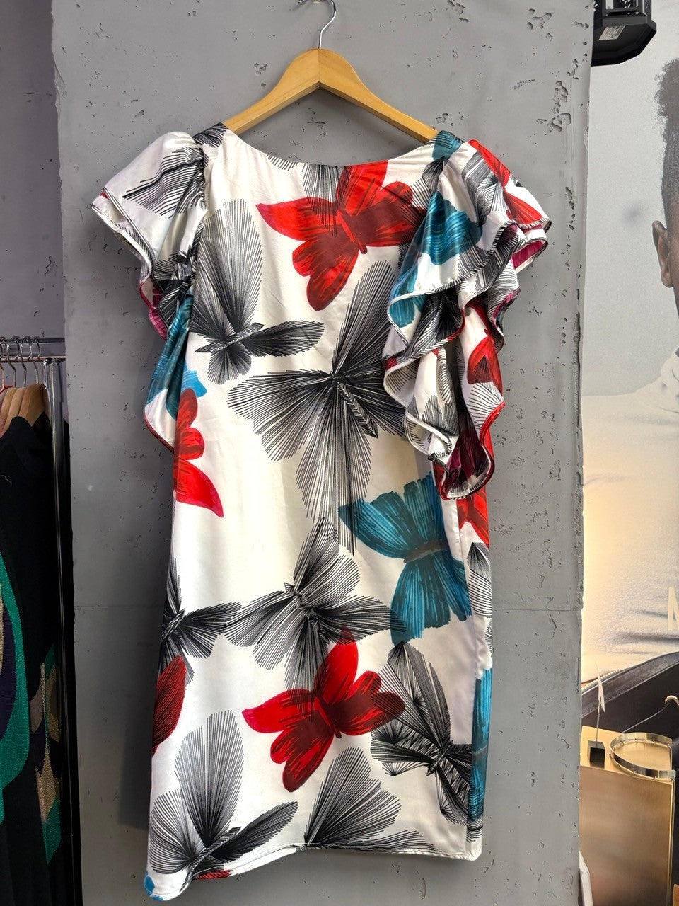 BERLIN VINTAGE CORNER white silk blend dress with red, blue, and black butterfly print and ruffled sleeves.