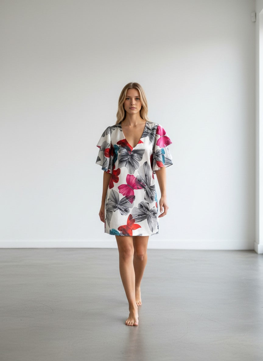BERLIN VINTAGE CORNER white silk blend dress with butterfly print, ruffled sleeves, and V-neck. Red, blue, black accents.