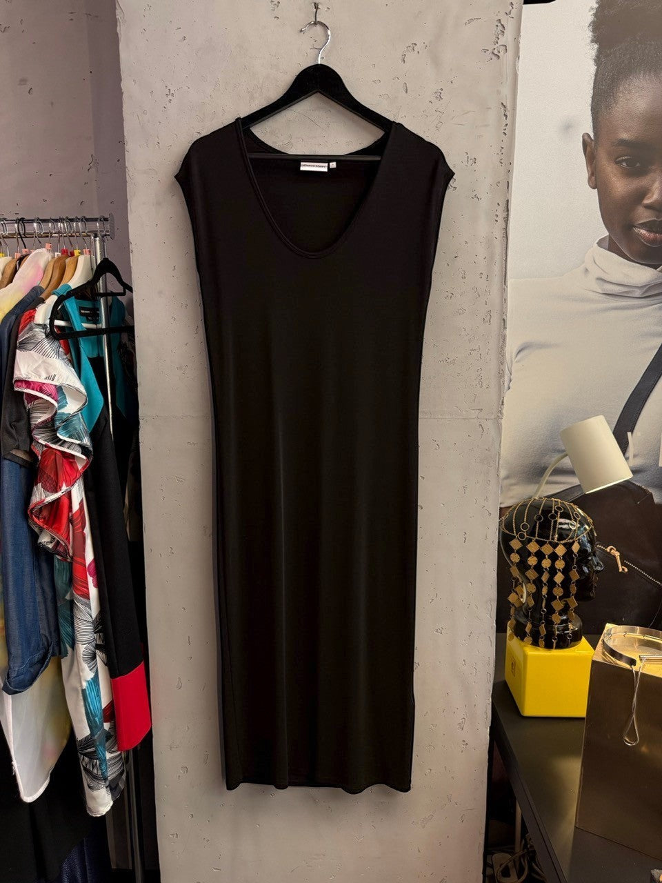 BERLIN VINTAGE CORNER black Calvin Klein sleeveless midi dress with a V-neckline hanging on a black hanger.
