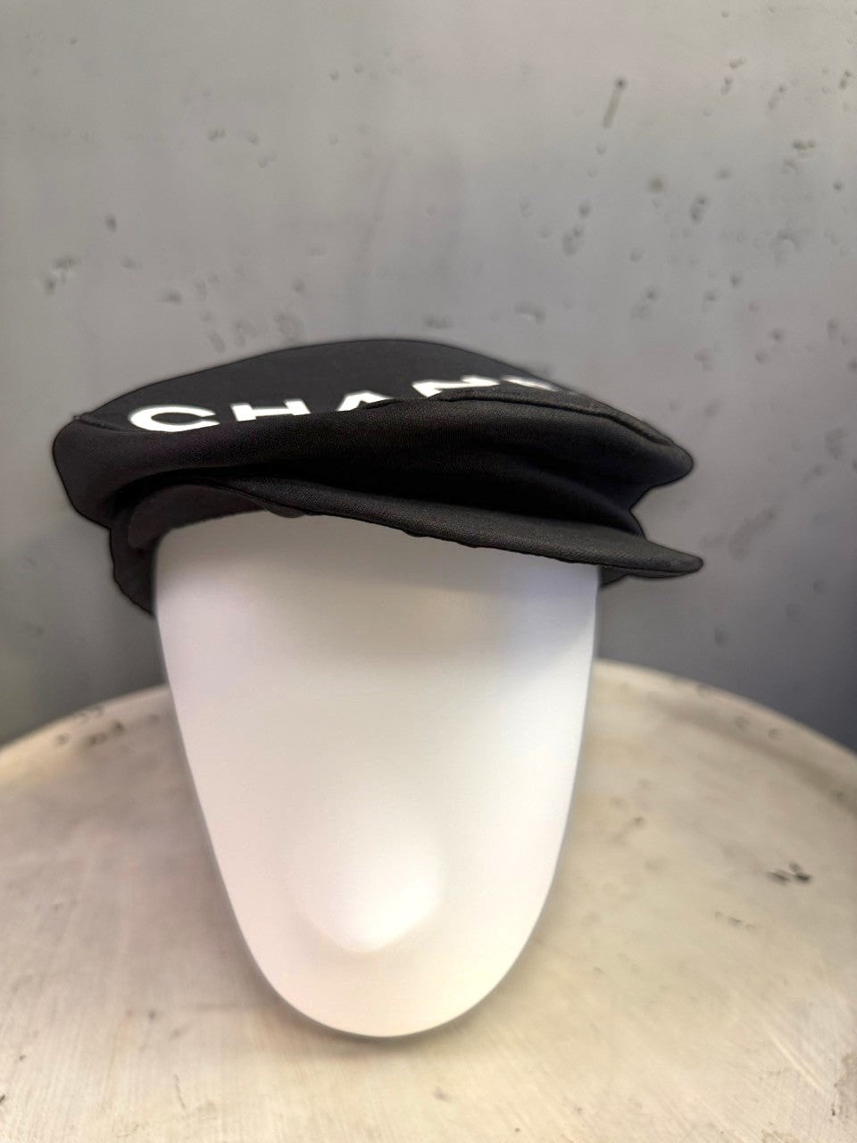BERLIN VINTAGE CORNER black CHANEL newsboy cap with white lettering on a mannequin head