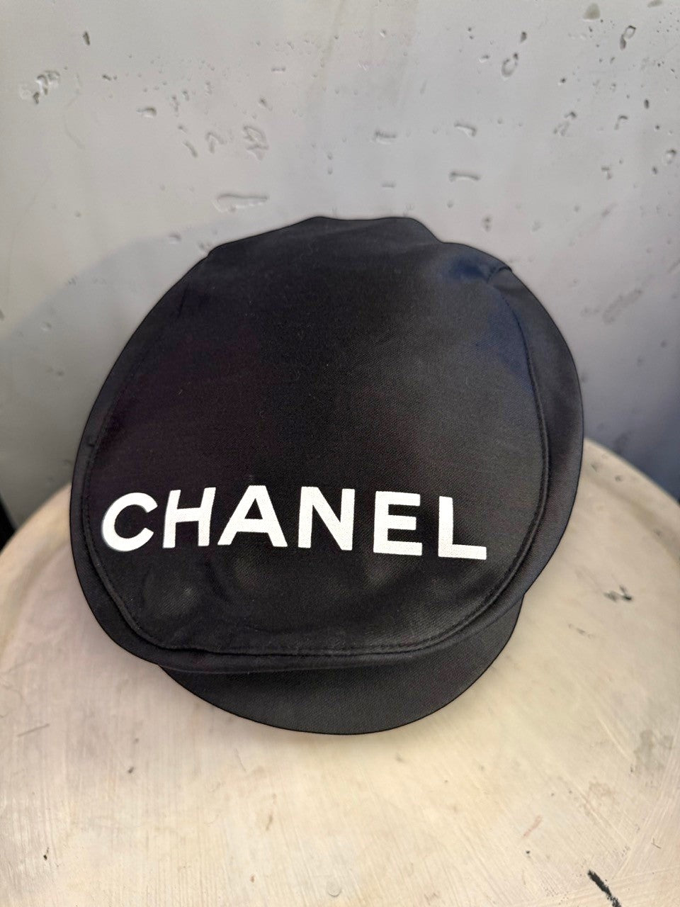 BERLIN VINTAGE CORNER black CHANEL newsboy cap with bold white logo lettering on the front