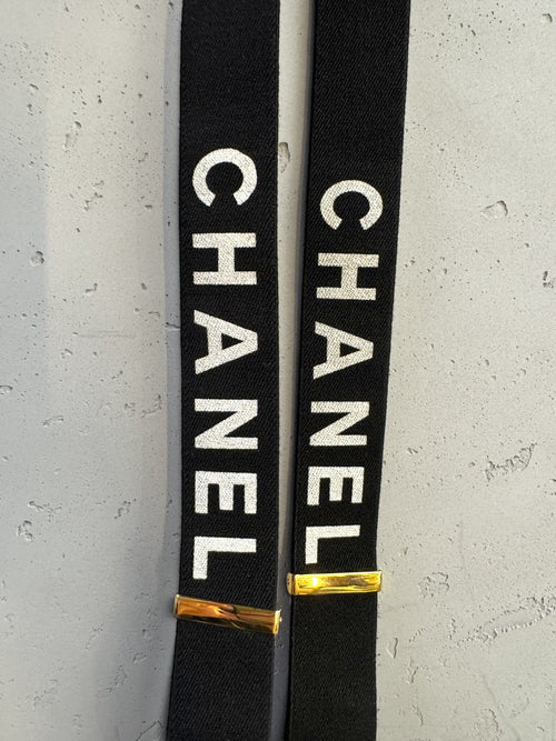 BERLIN VINTAGE CORNER black elastic CHANEL suspenders with white logo print and gold-tone hardware details