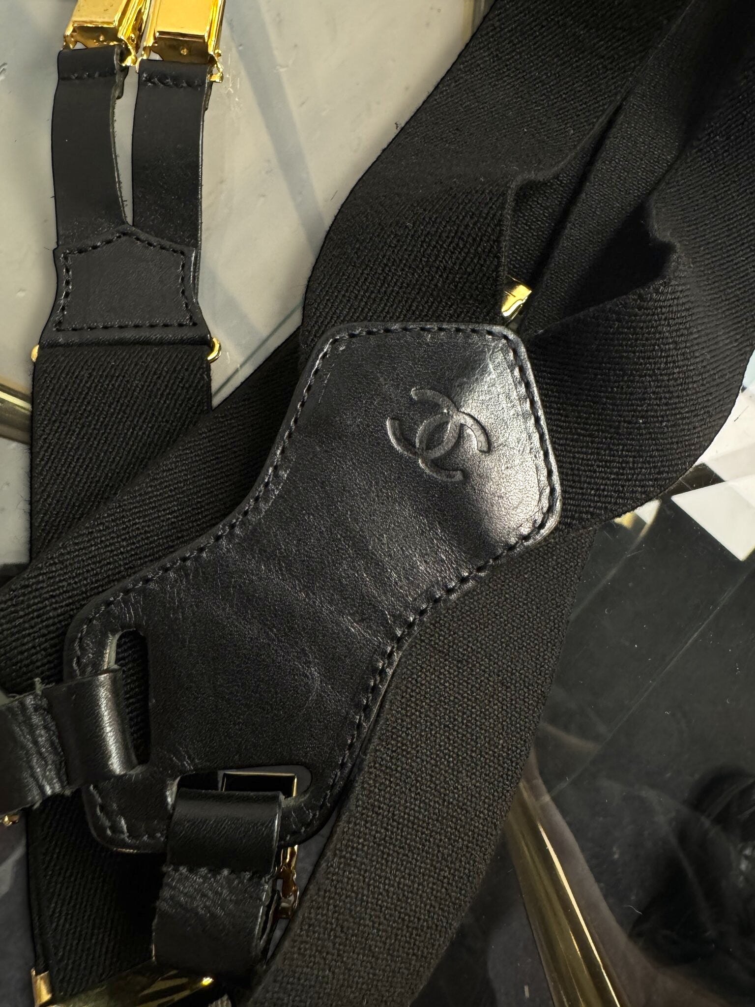 BERLIN VINTAGE CORNER black elastic CHANEL suspenders with premium leather detailing and gold-toned hardware.