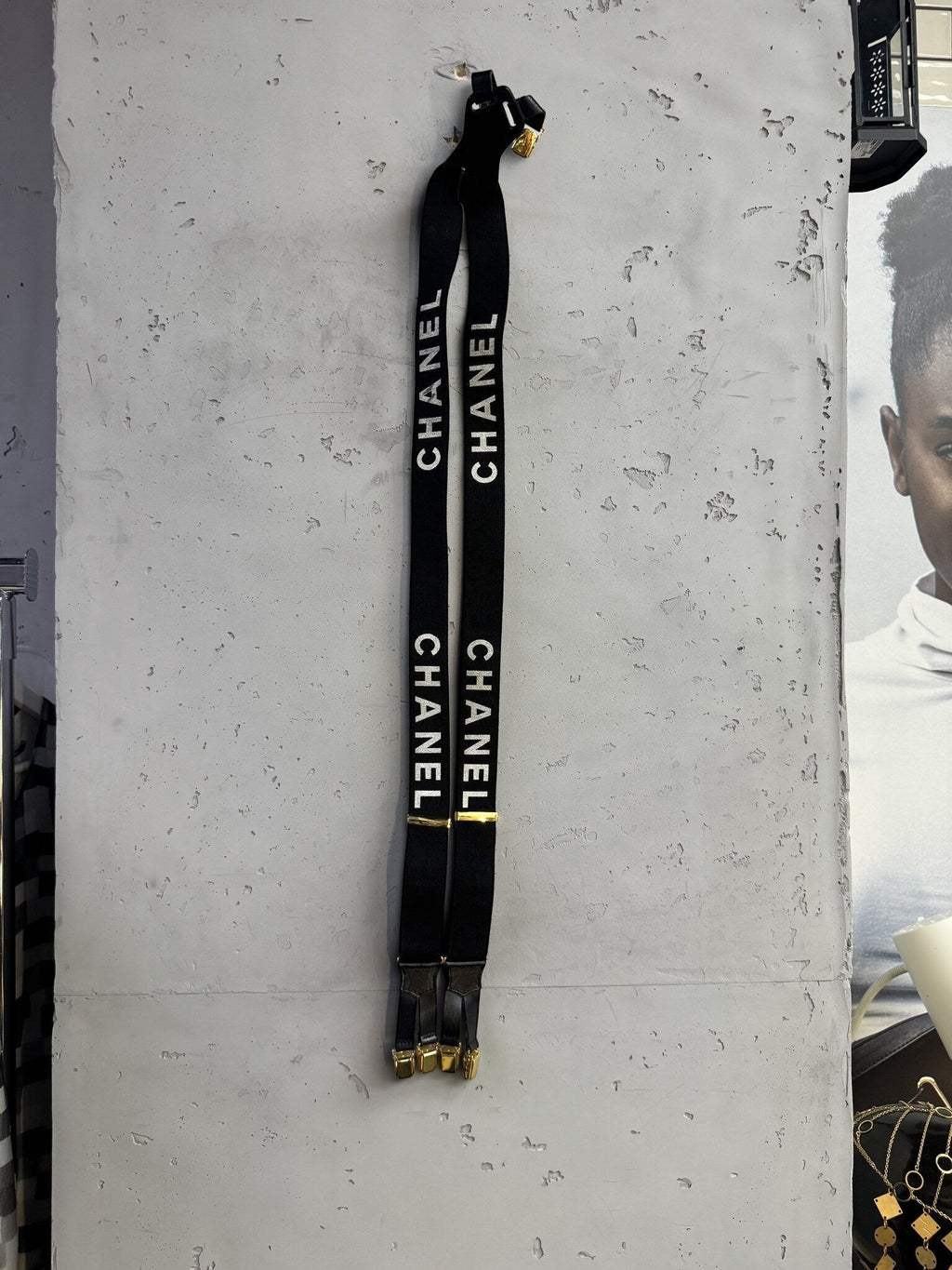 BERLIN VINTAGE CORNER black elastic CHANEL logo suspenders with gold-tone hardware and leather attachment details