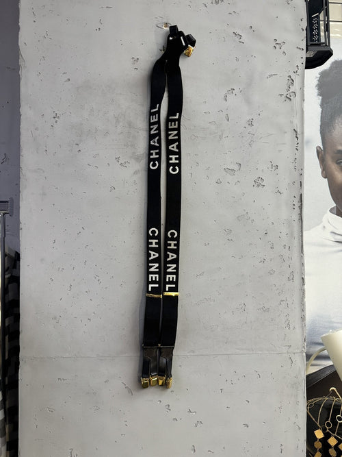 BERLIN VINTAGE CORNER black elastic CHANEL logo suspenders with gold-tone hardware and leather attachment details