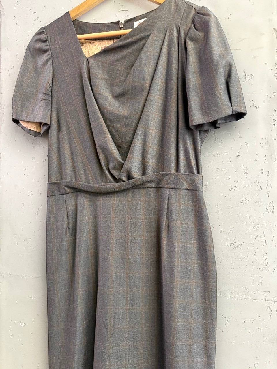BERLIN VINTAGE CORNER charcoal grey pinstripe wrap front midi dress with puffed sleeves and V-neckline.