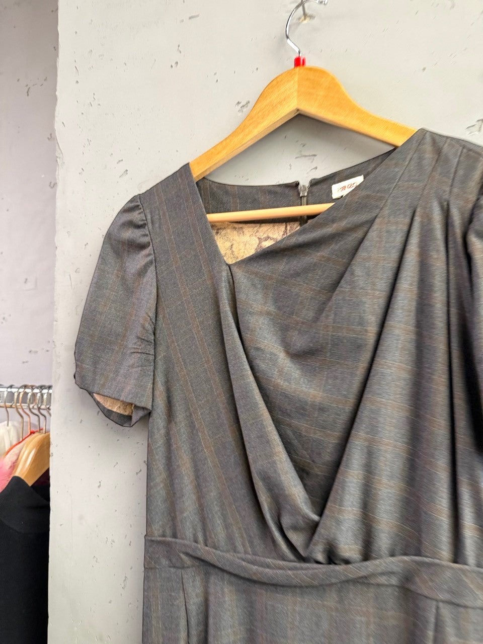 BERLIN VINTAGE CORNER charcoal grey pinstripe wrap midi dress with V-neckline and puffed sleeves.