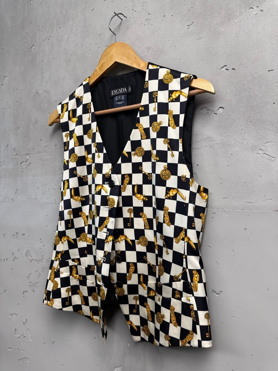 BERLIN VINTAGE CORNER black and white checkerboard vest with gold key and clock print. Sleeveless V-neck vest with button front.