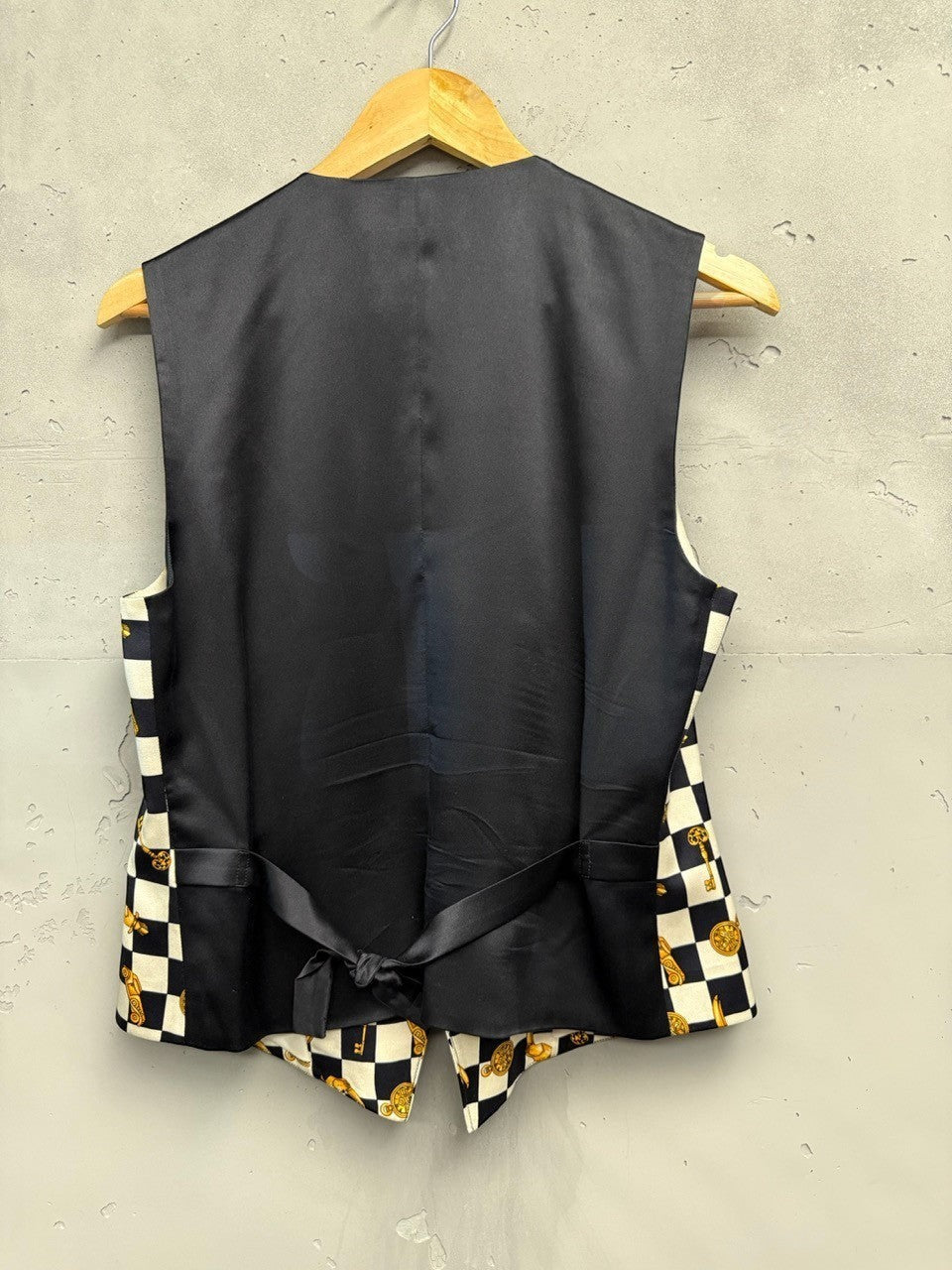 BERLIN VINTAGE CORNER black and white checkerboard vest with gold key and clock print. Sleeveless V-neck vest with button front.