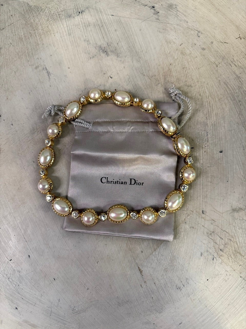Christian Dior gold-tone necklace with alternating pearls and crystals. Features unique pearl shapes and sparkling clear crystals.