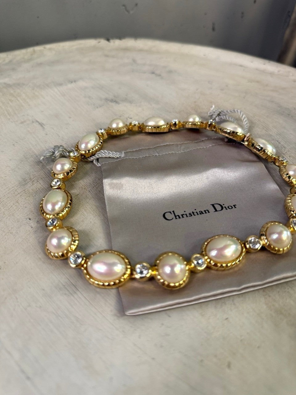Christian Dior gold-tone necklace with alternating pearls and crystals. Features unique pearl shapes and sparkling clear crystals.