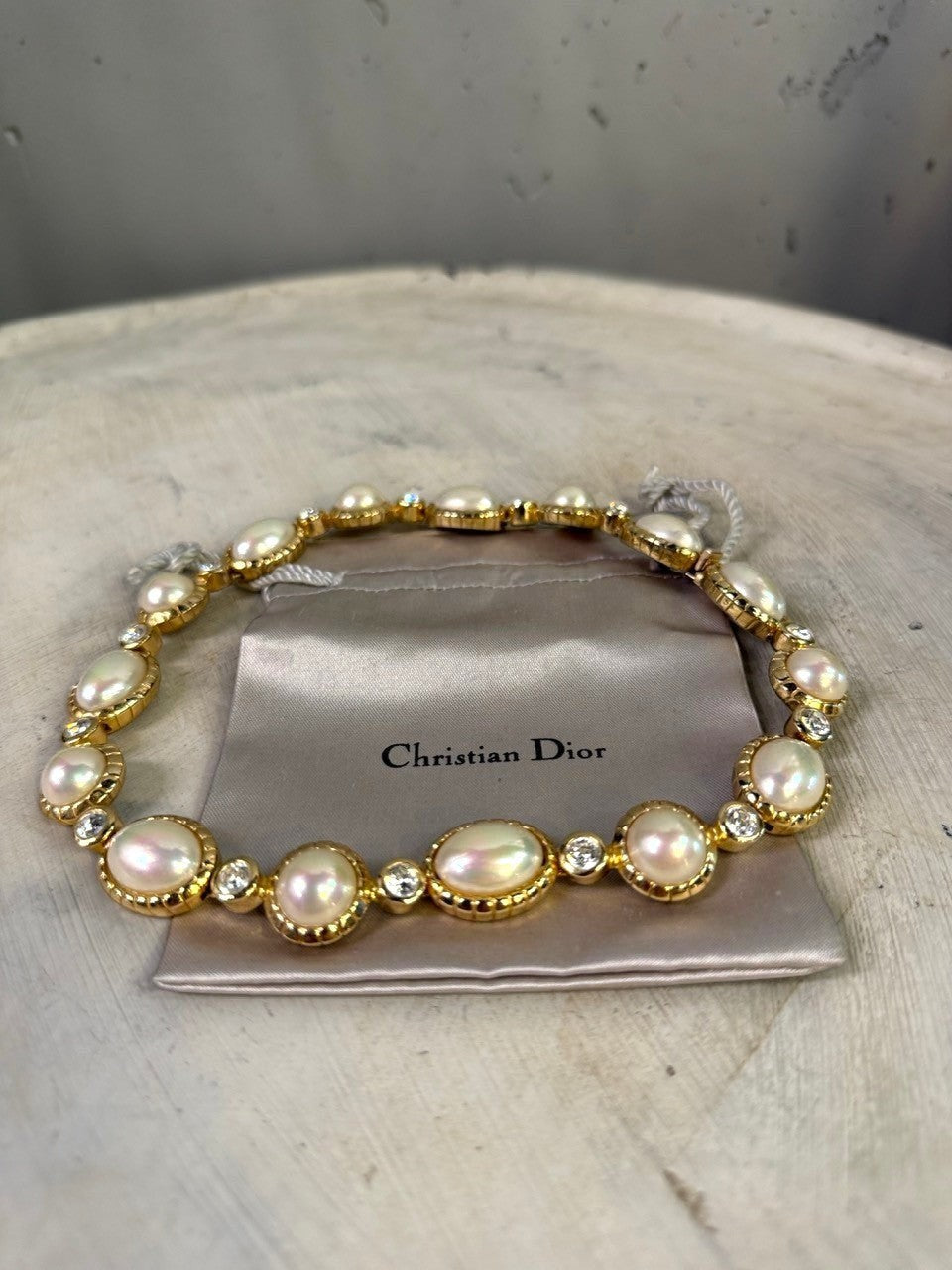 Christian Dior gold-tone necklace with alternating pearls and crystals. Features unique pearl shapes and sparkling clear crystals.