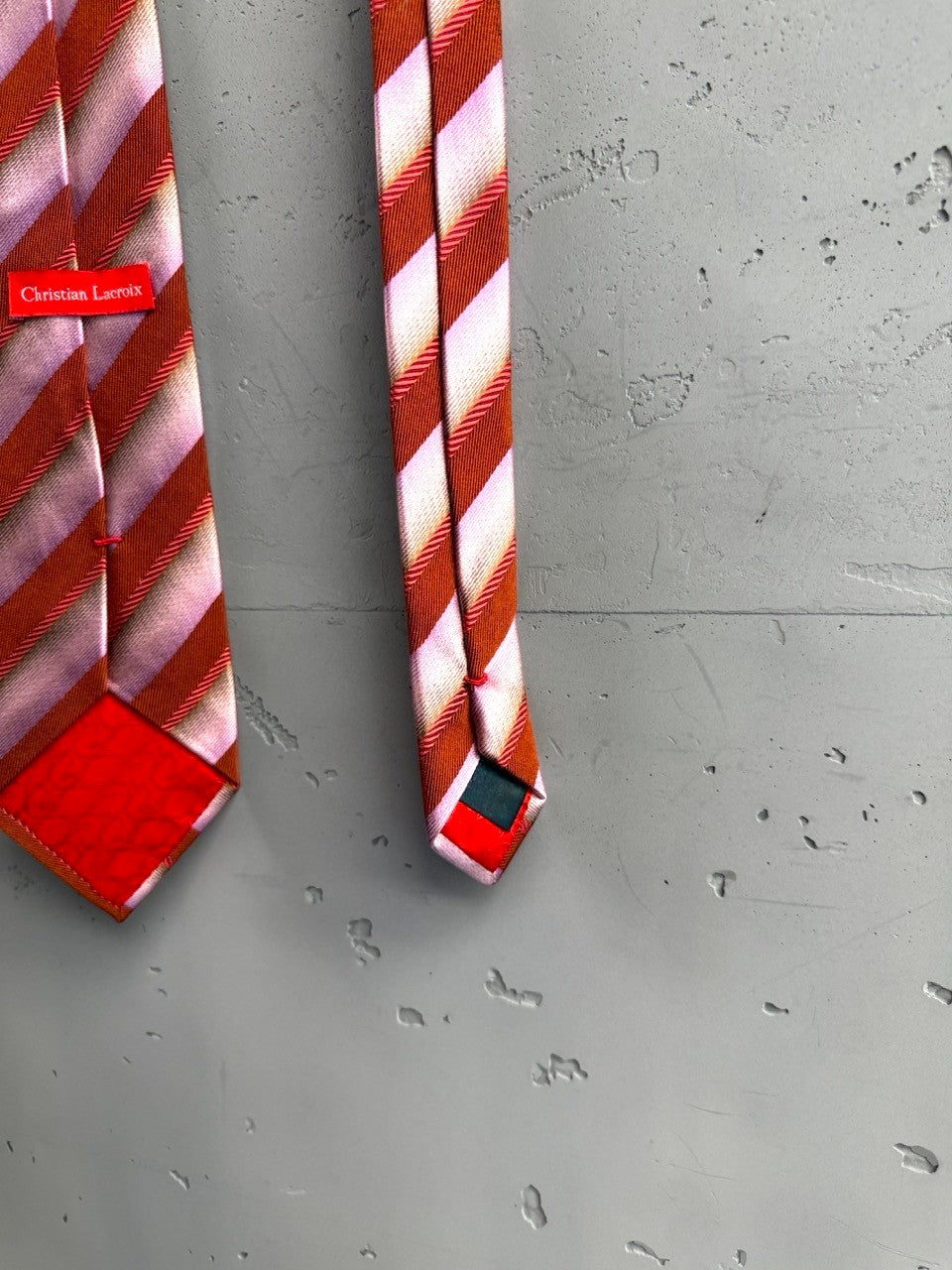 BERLIN VINTAGE CORNER Christian Lacroix silk necktie with diagonal pink and burnt orange stripes. Features red accent at tip.