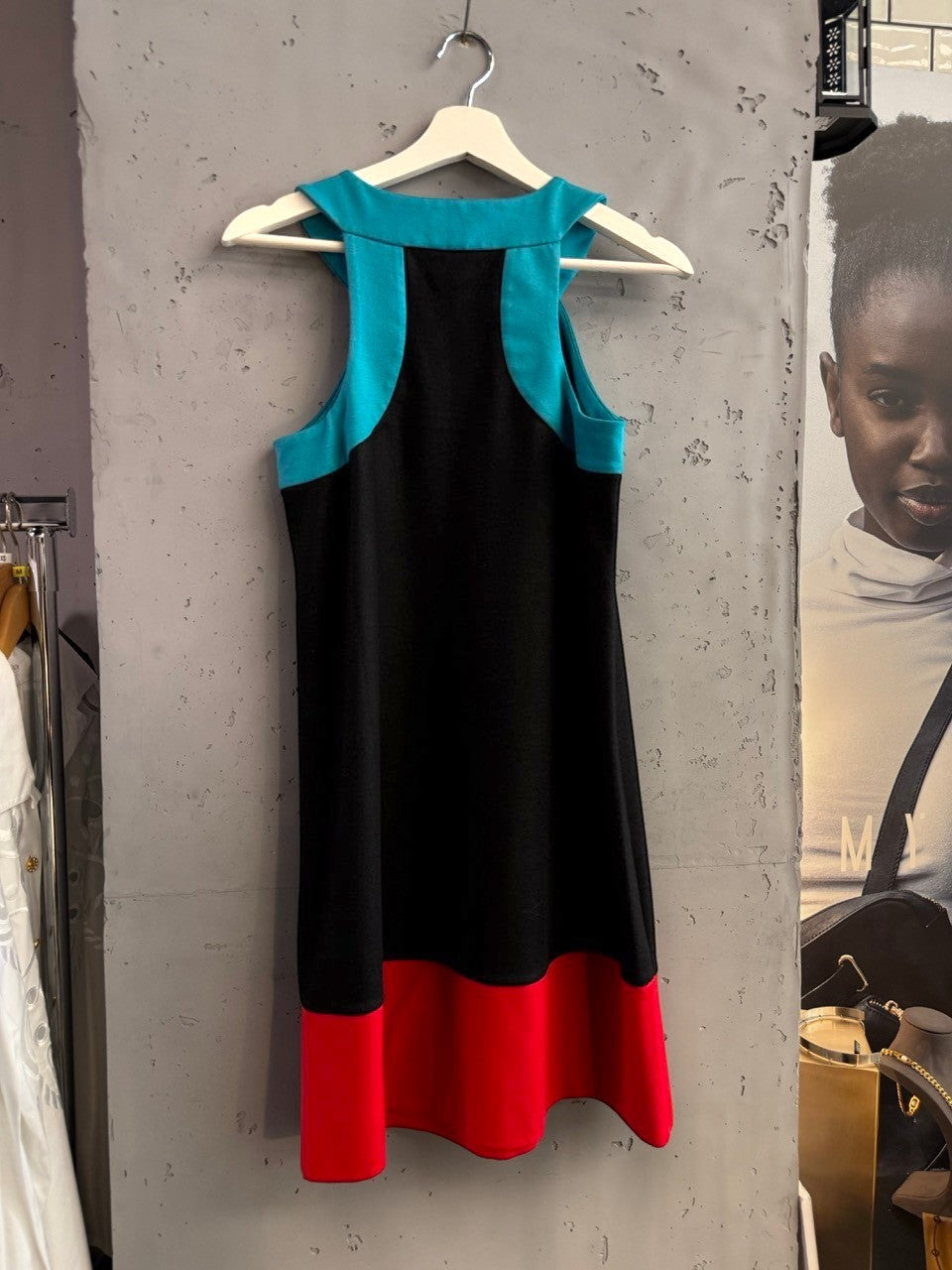 BERLIN VINTAGE CORNER sleeveless A-line mini dress with black body, turquoise neckline accents, and red hem.