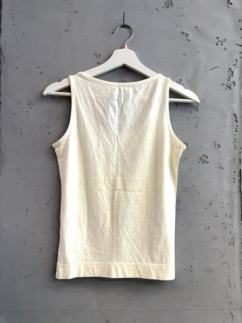 BERLIN VINTAGE CORNER cream cotton Adidas tank top with olive green trefoil logo on chest. Sleeveless, scoop neck, ribbed hem.
