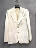 BERLIN VINTAGE CORNER cream cotton blend blazer with two-button closure, gold-tone buttons, notched lapel, and patch pockets.