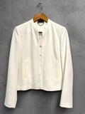 BERLIN VINTAGE CORNER cream cropped jacket with collarless neckline and hook-and-eye closure, made from smooth structured fabric.