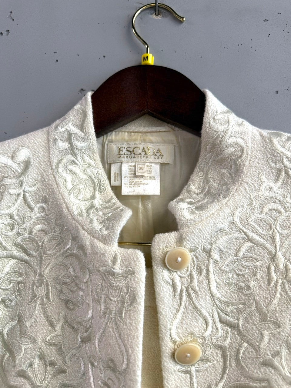 BERLIN VINTAGE CORNER cream wool silk blend jacket and skirt set with tonal embroidery and button closure.