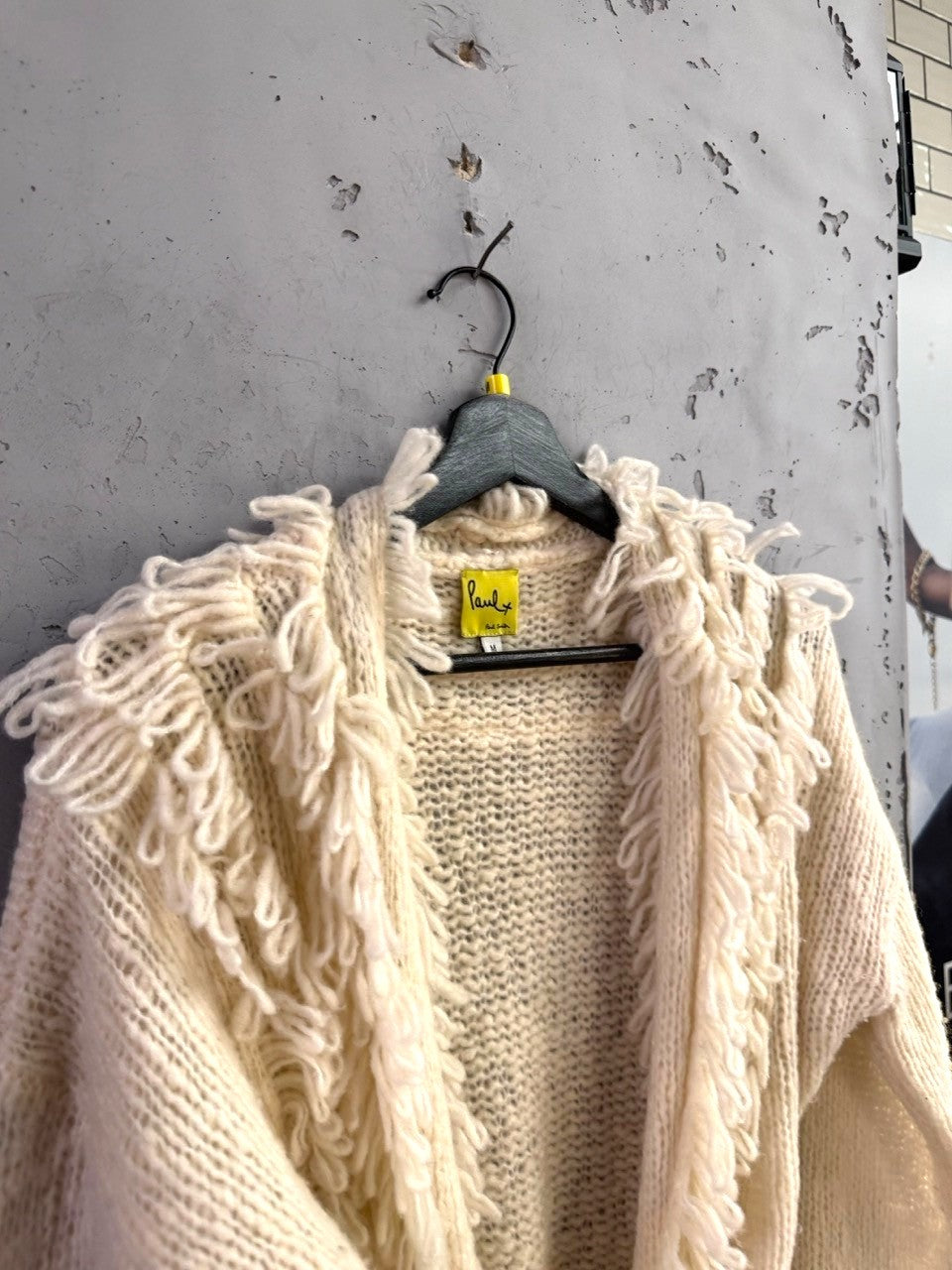 BERLIN VINTAGE CORNER cream chunky knit Paul Smith cardigan with fringe trim detail on a hanger