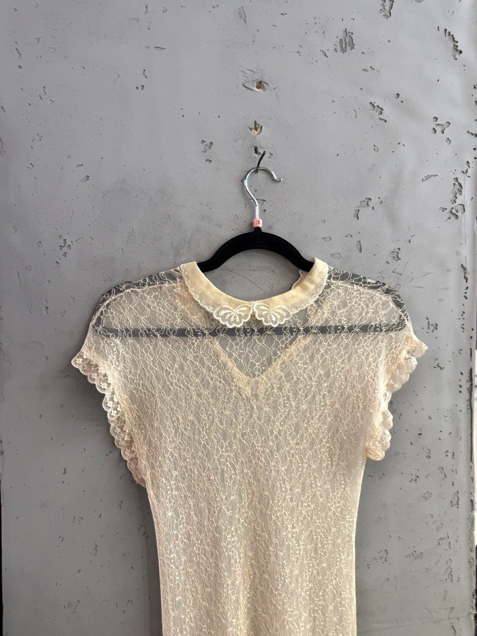 BERLIN VINTAGE CORNER cream lace midi dress with a delicate collar and intricate floral pattern on a hanger.