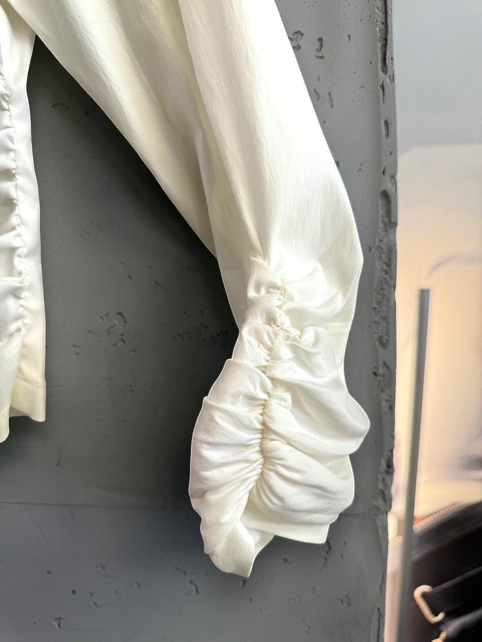 BERLIN VINTAGE CORNER cream long sleeve blouse featuring delicate ruched detailing on the sleeves and soft fabric.