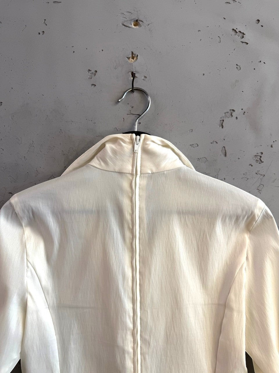 BERLIN VINTAGE CORNER cream long sleeve blouse featuring a high neckline and vertical back zipper closure